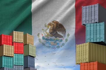 Mexico flag and big stack of shipping cargo containers in docks with sky background close up