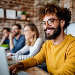 Obraz premium Young creative smiling while working on laptop in busy office