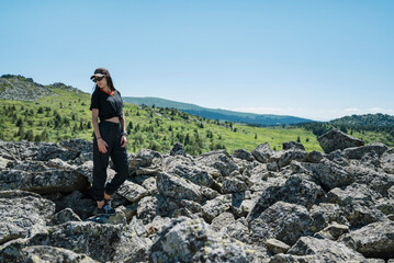 Traveler Woman standing on a rocks in the  summer mountain .Vitosha Mountain ,Bulgaria 