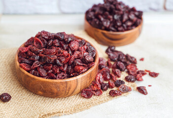 Dried cranberries in wooden bowl 
