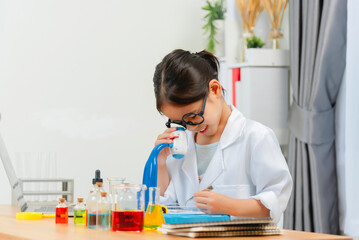 young Asia girl Scientist Conducting Experiment With Microscope In Laboratory