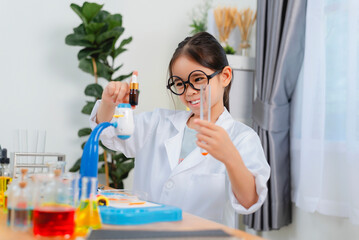 young Asia girl Scientist Conducting Experiment With Microscope In Laboratory