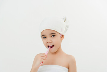 Smiling Child Brushing Teeth in Bathroom With Towel Wrap