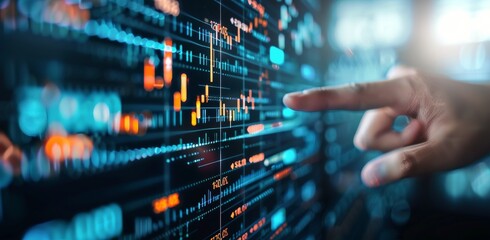 Fototapeta premium Hand Pointing at Stock Market Data
