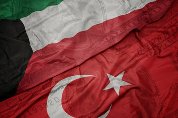 waving colorful flag of kuwait and national flag of turkey on the dollar money background. finance concept.