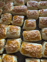 Freshly baked bread rolls with a golden crust and cheese topping