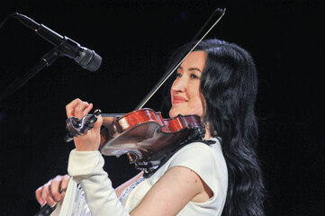 Young pretty virtuoso violinist playing violin