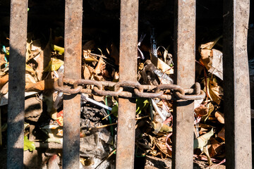aqueducts with iron barriers and clogged chains of leaf litter