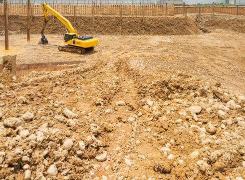 A digger in a pit a foundation for a building on a construction site.