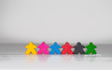 Wooden colorful figures of people on a white background. Concept of diversity and inclusion
