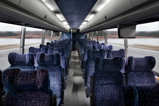 Interior view of passenger seating in a bus, in rows.