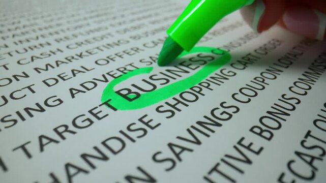 Close up shot of woman hand working with document, green marker in female hand marked circled a word business in text.
