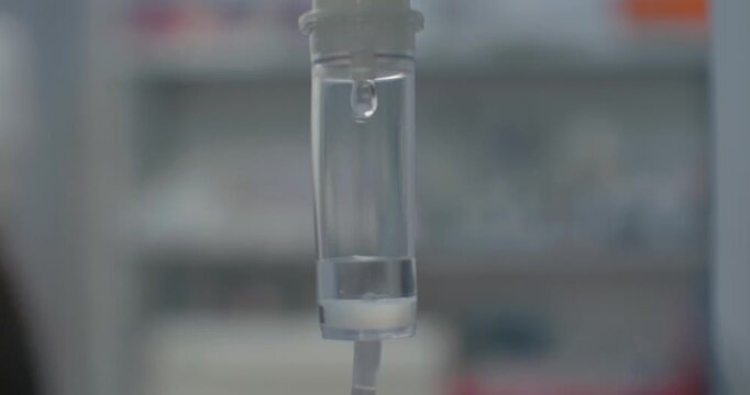 Intravenous drip close-up. Drops dripping in an intravenous drip system close-up. In surgery, a drip of saline solution is dripping.