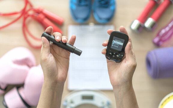 Diabetes monitoring with blood sugar test, glocuse measurement for diabetic disease awareness control for analyzing insulin-deficient illness patient with exercise sport gym equipment background