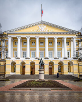The Smolny Institute, a Palladian style 18th century building with pillar and pediment, and a statue of Lenin in the courtyard.