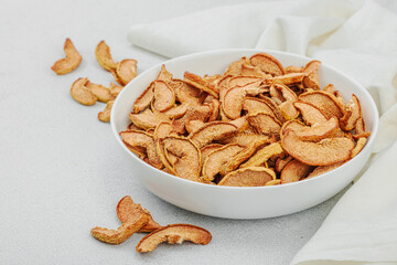 Dry pieces of apple in a bowl. Healthy food diet, vegan lifestyle, lose weight concept