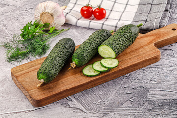 Raw green cucumbers with slices