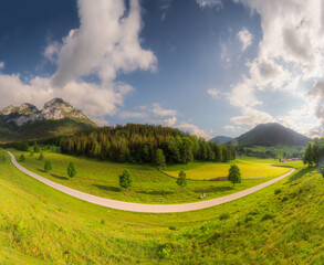 Meadow with road and bench during sunset in Berchtesgaden National Park