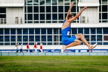 long jump men, athlete in flight, athletics competition