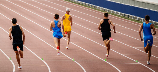 Fototapeta premium rear view group men running 800-meter race