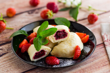 cooked sweet homemade steamed dumplings with strawberries