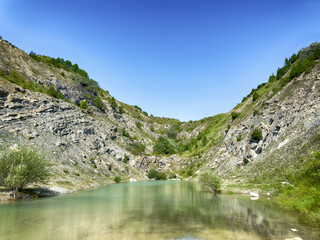 A wonderful landscape in the Carpathian mountains with a view of the lake between the rocks in sunny weather