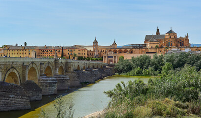 Panoramic view of the Mosque-Cathedral across the Calahorra Tower and the Roman Bridge over the Guadalquivir River, Cordoba, Andalusia, Spain.