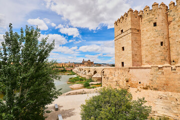 Fototapeta premium Panoramic view of the Mosque-Cathedral across the Calahorra Tower and the Roman Bridge over the Guadalquivir River, Cordoba, Andalusia, Spain.