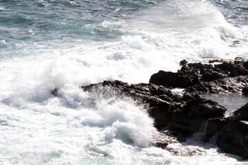 evocative image of a rough sea hitting the rocks in Sicily