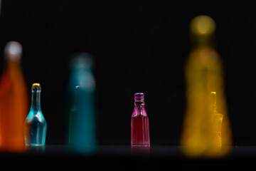 various miniature bottles of alcohol without labels with black bacground