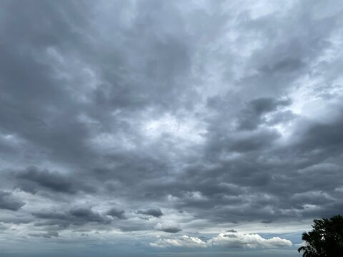 Image of a sky with dense rain clouds covering the entire sky. It's slightly smoky gray and white gives it a dull look.