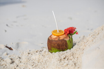 Tropical cocktail in a coconut on a beautiful beach, paradise, exotic holiday, white sand, ocean