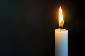 White Candle. Candle Flame on Black Background for Decoration and Light Atmosphere