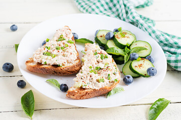 Toasts with tuna. Italian bruschetta sandwiches with pate canned tuna, egg and cucumber.