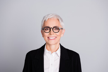 Photo portrait of pretty senior female professional entrepreneur cheerful smile wear formalwear specs isolated on gray color background