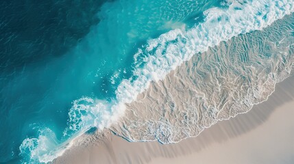 A bird's-eye view of a beautiful tropical beach with white sandy shores, clear blue water, and gentle waves meeting the coastline, perfect for a summer vacation.
