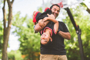 Basketball, family and teaching sport with a dad and son training on a court outside for leisure fitness and fun