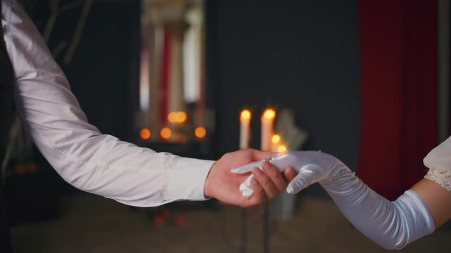 Hands closeup part of body romantic couple in love,man and woman go to medieval ball. king invites queen to dance, prince guy offers hand to sexy princess girl. Vintage white classic gloves. art 4k