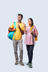 Obraz premium Two Happy Indian College Students with Bags and Laptop, Isolated on White Background