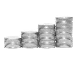 Stacks of shiny silver coins arranged in ascending order, symbolizing financial growth, investment, savings, wealth accumulation, and economic success on a white background