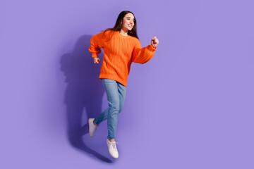 Photo of funny nice positive adorable girl wear stylish clothes run fast empty space isolated on violet color background