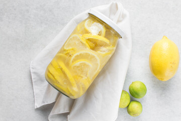 lemon cheong in a glass jar on a white background, korean lemon cheong in a transparent jar, lemon slices in sugar syrup
