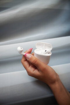 heand holding earphones
