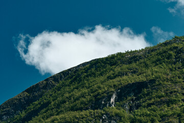 A cloud above the hillside of the Utladalen Valley in summer.