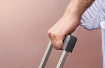 Closeup Of Male Hand Holding Suitcase Handle Outdoors, Ready For Travel, Selective Focus, Cropped Image With Copy Space
