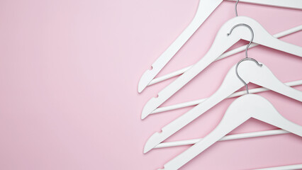 Creative flat lay hangers pink background. Sale discount store promo shopping concept. Top view. Copy space