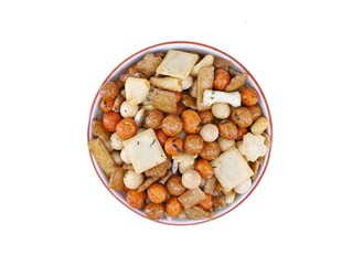 Selection of japanese rice crackers in a ceramic bowl on white background.