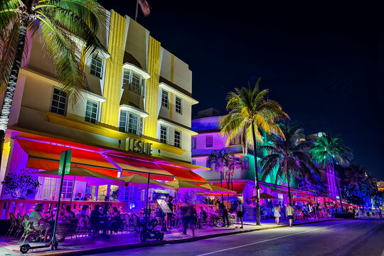 Miami Beach, Florida - July 8, 2024: Vibrant and colorful night scene of Leslie Hotel and other historic art deco buildings on Ocean Drive in South Beach.