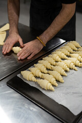 hands Preparing uncooked croissants for baking bakery concept