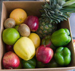 Box with fruits and vegetables food help.